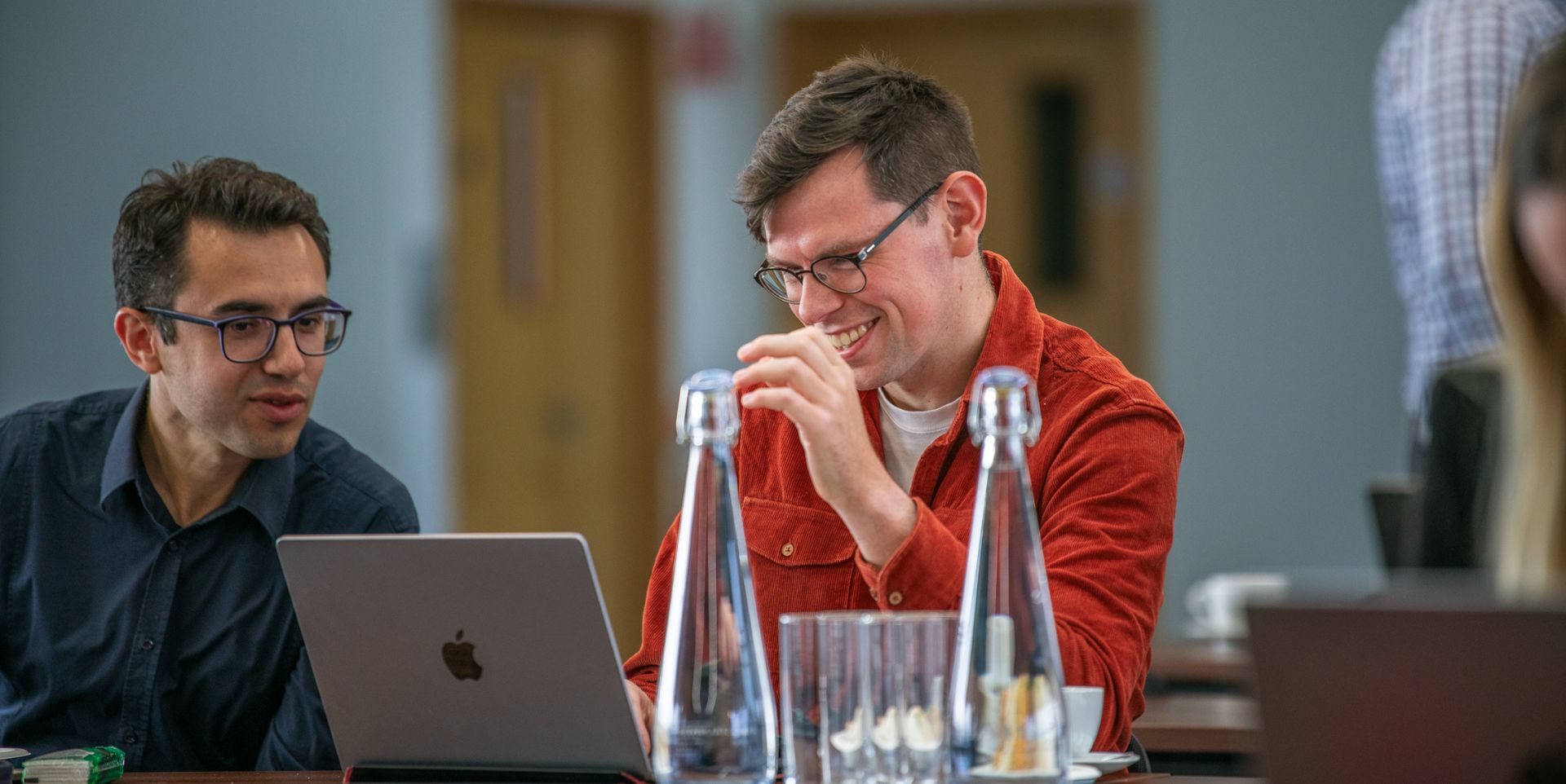 Life Sciences communications at Pioneer Group: image shows two men looking at a laptop screen during our neurotechnology accelerator programme.