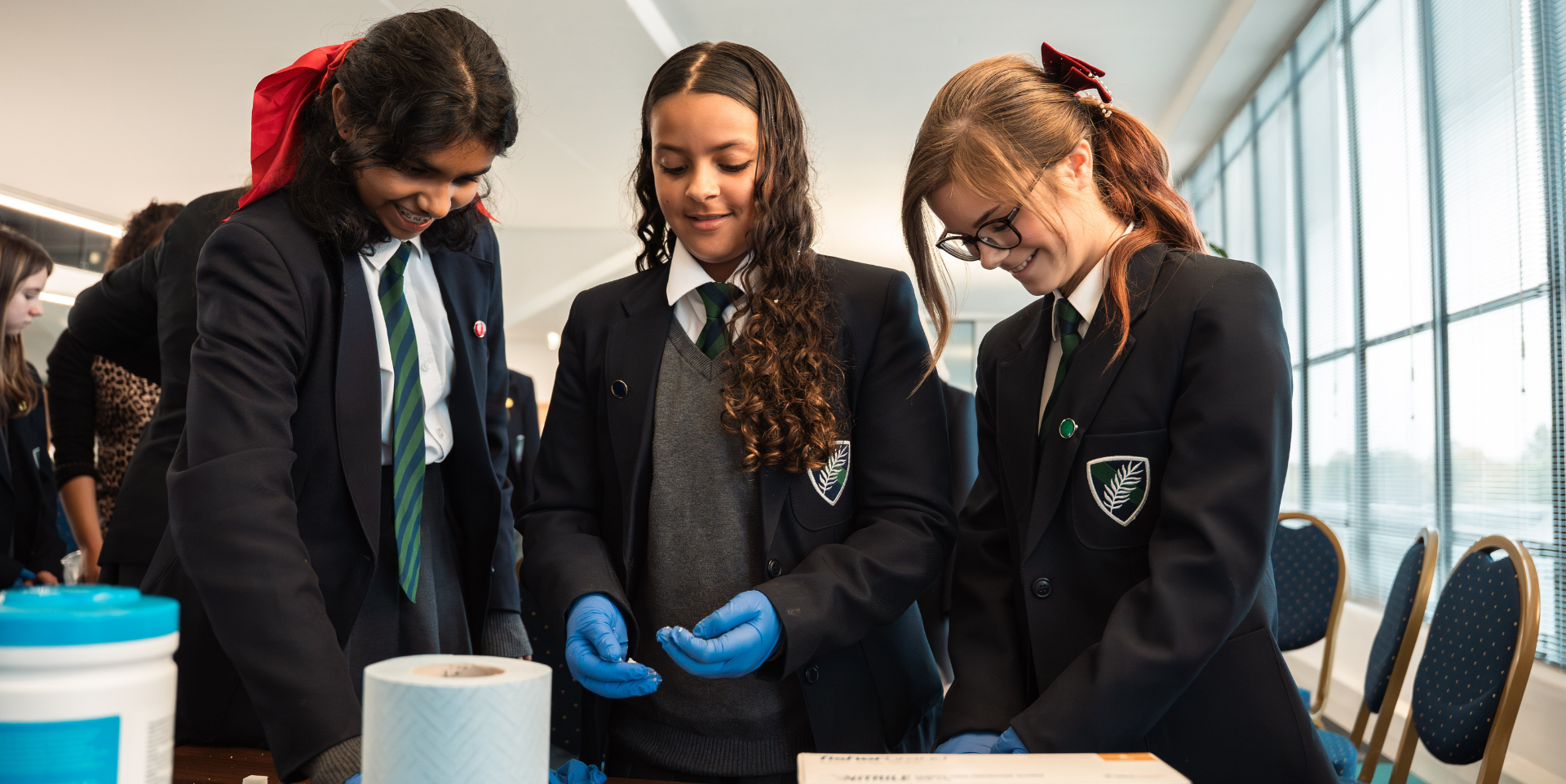 School children participating in hand-on STEM activities while laughing and smiling.