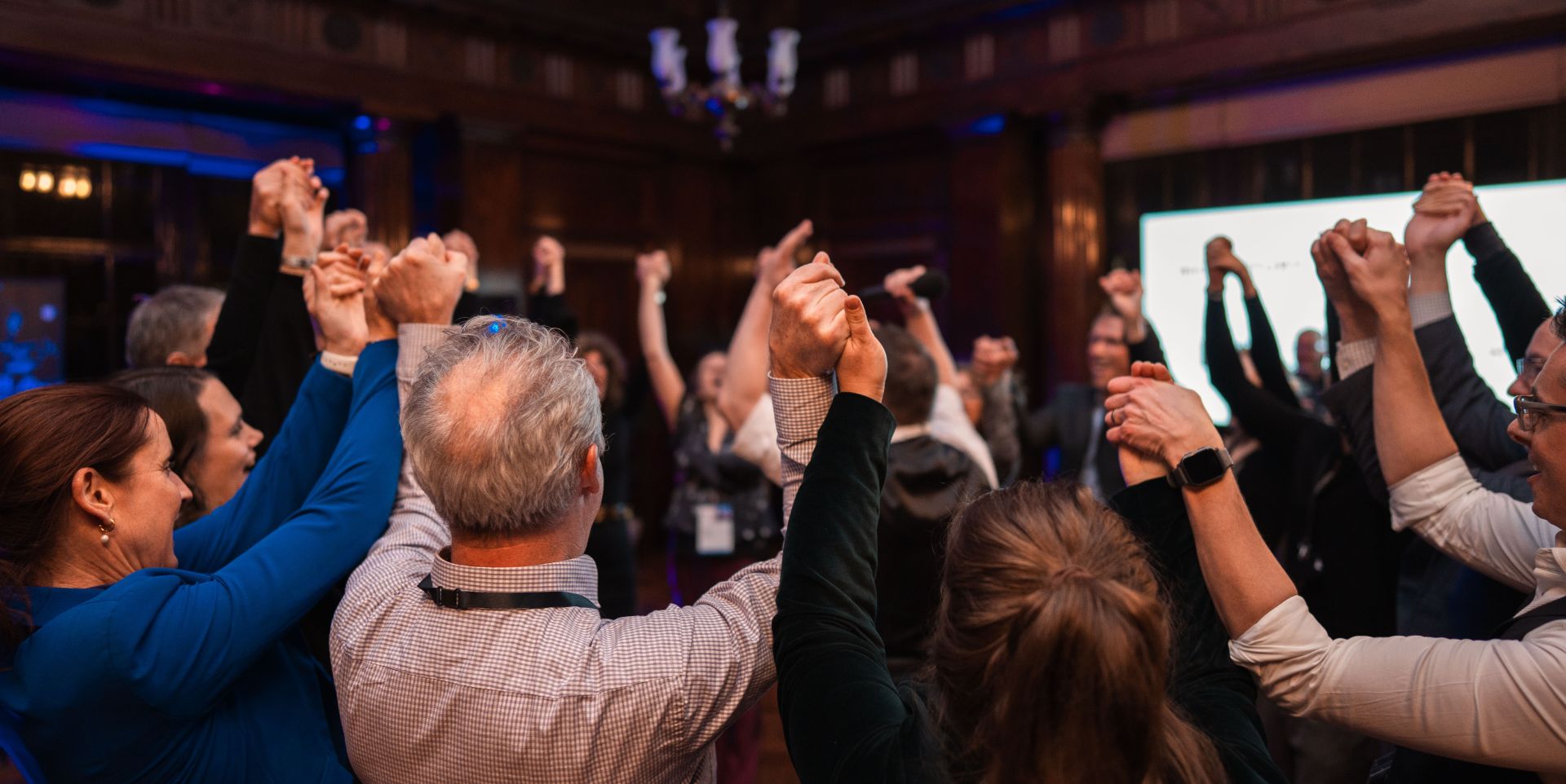 London Life Sciences Week 2025 - a group of people are dancing and holding hands in a circle, taking part in a traditional Ceilidh at Victoria House