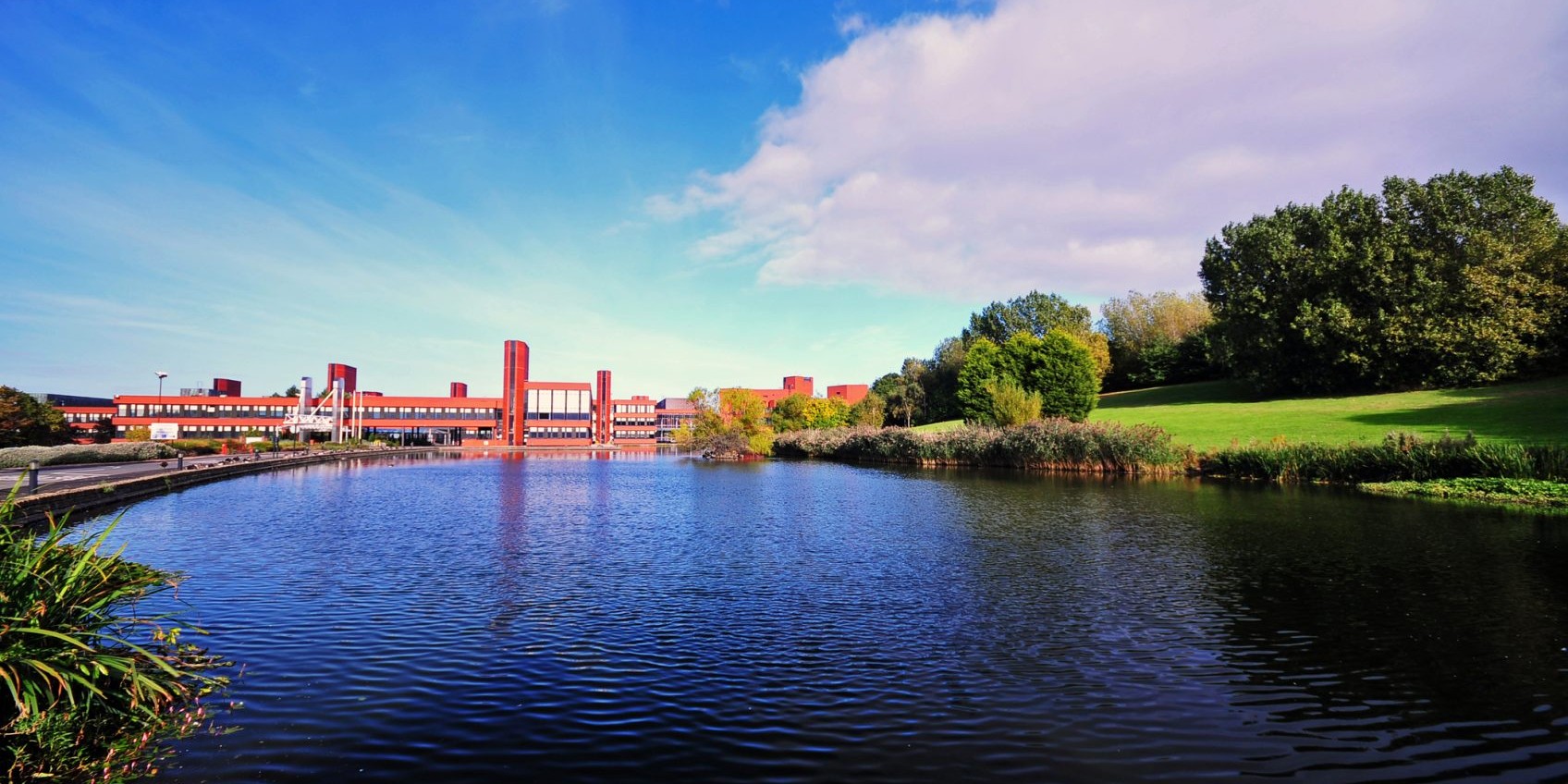 The landscape of trees and a lake surrounding Wilton Centre in the distance.