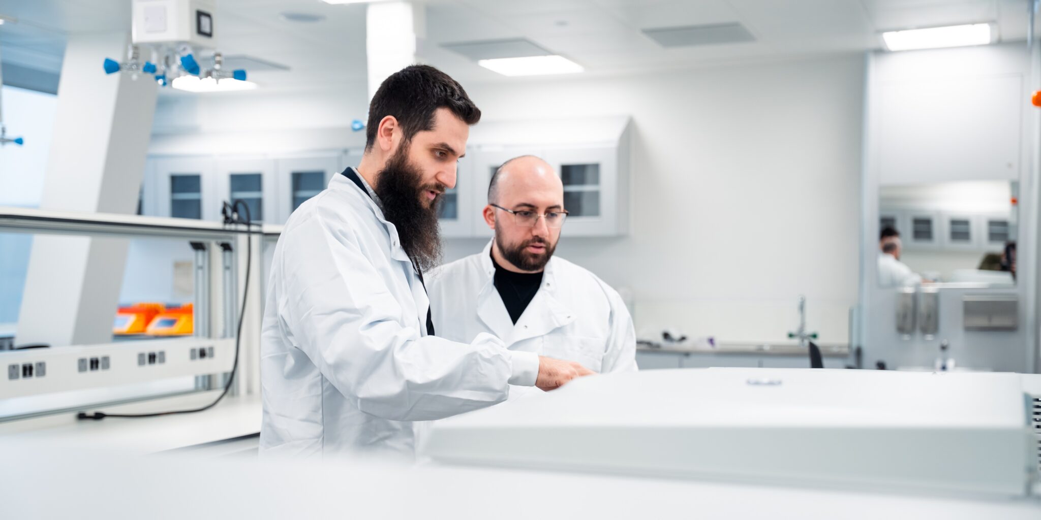 Scientists at Victoria House using the shared lab space on Floor 7.