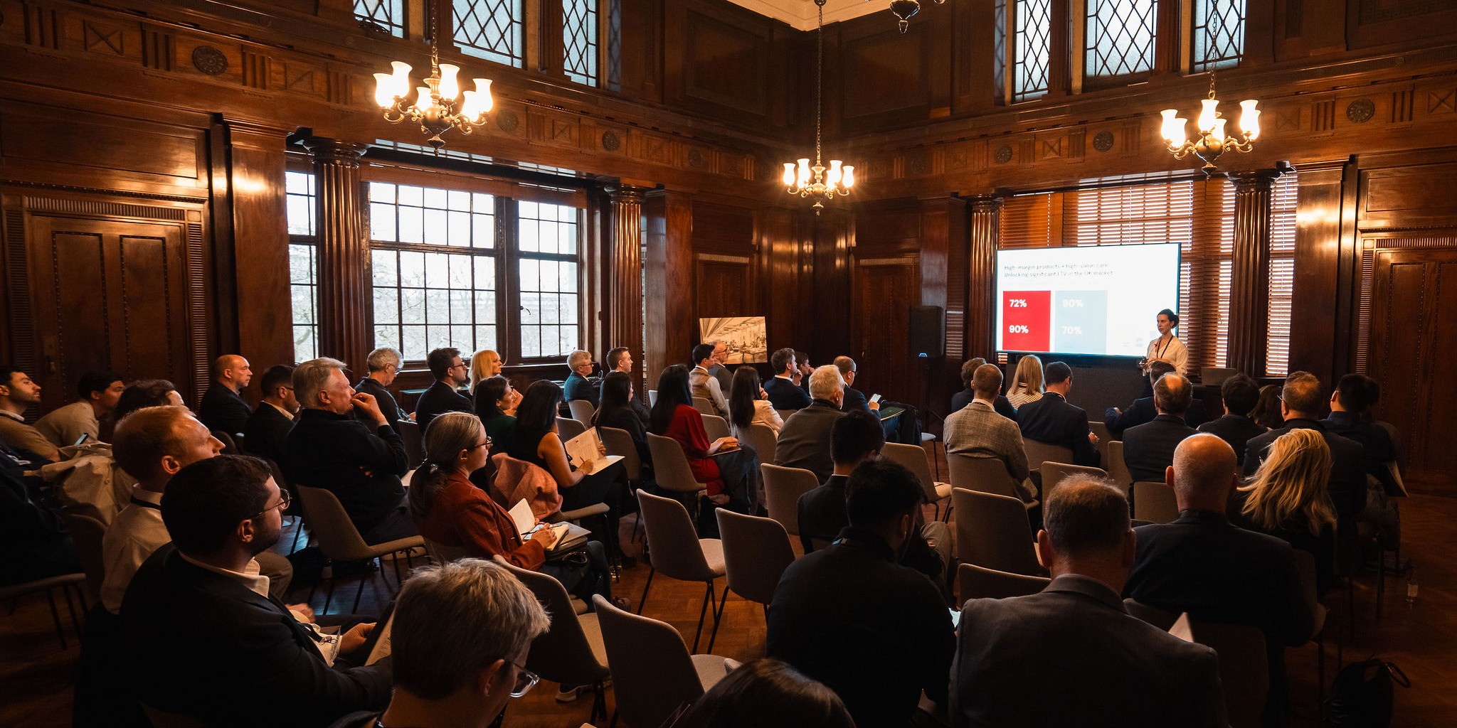 Founders and investors attending Pioneer’s Investment Showcase at Victoria House, listening to a presentation on emerging ventures.