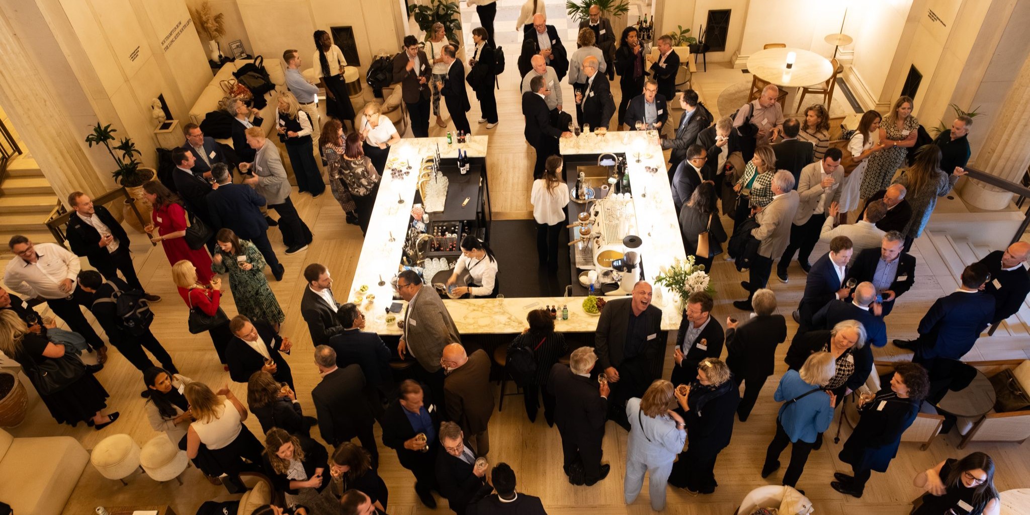 Attendees networking in the atrium at Victoria House during a life sciences event.