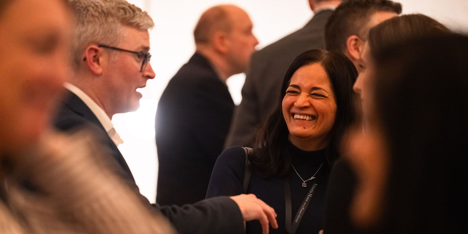 Guests laughing and chatting at an event.